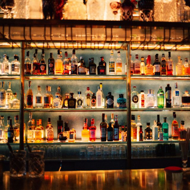 The shelf behind the bar with  great variety of spirits, such as COMPANION Aperitivo, Bacardi Rum, Hendricks Gin, Beefeater Gin and others